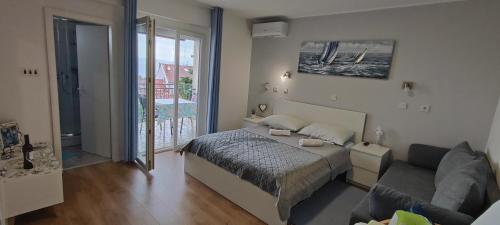 1 dormitorio con 1 cama y 1 sofá en Bicanic Apartments and Rooms en Crikvenica