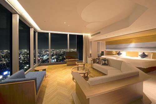 a hotel room with a bed and a view of a city at Nagoya Prince Hotel Sky Tower in Nagoya