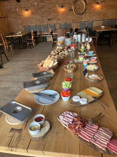 a long wooden table with food on it at Penzion Kolnička in Luka nad Jihlavou