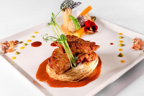 a plate of food on a white plate at Hôtel & SPA Château de La Côte - Brantôme in Biras