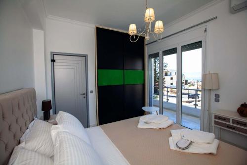 a bedroom with a bed with two towels on it at Bourtzi View Villa in Nafplio