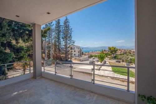 a large balcony with a view of a city at Bourtzi View Villa in Nafplio