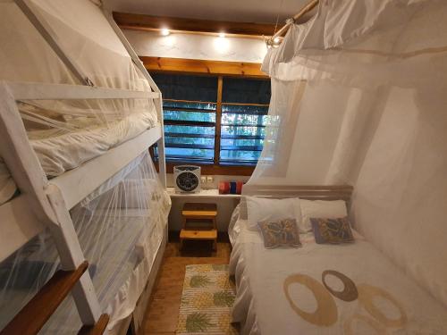 a small room with two bunk beds in it at Sunset View Tofo in Praia do Tofo