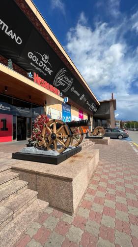 a store with a wheel in front of a building at New Apartment with a View in the Town Center in Narva