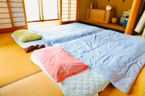 a large bed with two pillows in a room at まんのう清流庵 in Manno