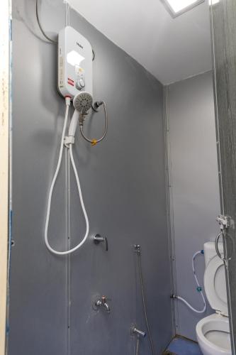a bathroom with a shower and a toilet at Familia Motel Kangar in Kangar