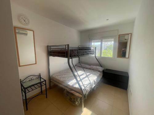 a bedroom with a bunk bed and a mirror at Condado De Alhama Golf Resort 2 Bedroom Apartment Jardine 13 in Murcia