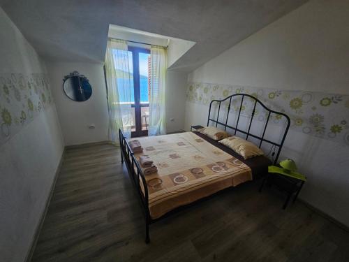 a bedroom with a bed in a room with a window at Villa Rose Ann in Rogoznica