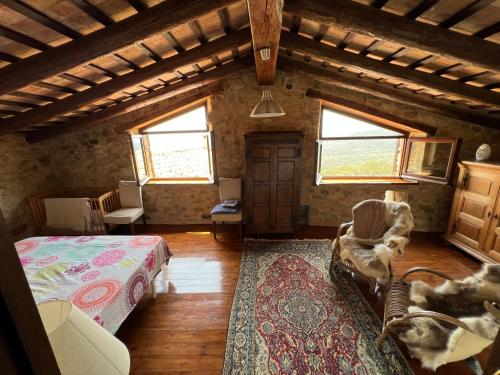 a bedroom with a bed and a chair in a room at Can Maimes in Agullana