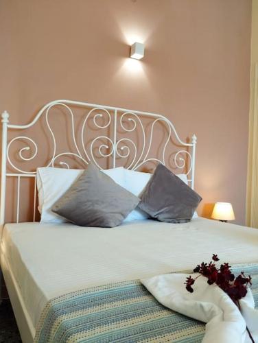 a bedroom with a white bed with two pillows at Vicky's central apartment in Korinthos