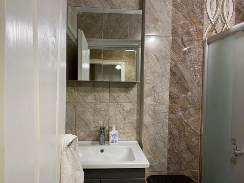 a bathroom with a sink and a mirror at Demir Apart in Trabzon