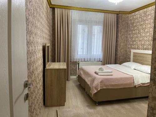 a hotel room with a bed and a window at Demir Apart in Trabzon