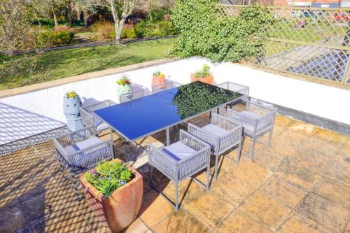 ウェスト・カービーにあるSeaside spacious 4 BR Nr Town centre pet friendly sailing & open golf courseのパティオ(テーブル、椅子付)が備わります。