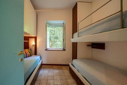 a bedroom with two bunk beds and a window at Blue Dolphin in Portofino