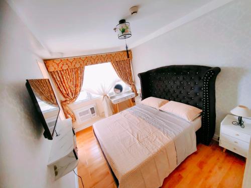 a bedroom with a bed and a window at Casa Felicitas 2 in Davao City