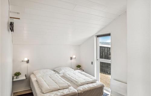 two beds in a room with a window at Stunning Home In Esbjerg V With Wifi in Esbjerg