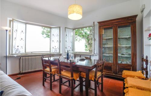 a dining room with a wooden table and chairs at Casa Per Vacanze Villa Ricci in San Quirico