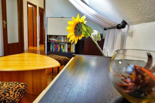 a living room with a table and a sunflower at Villa Vili - Jacuzzi, BBQ & EV Outlet in Limbuš