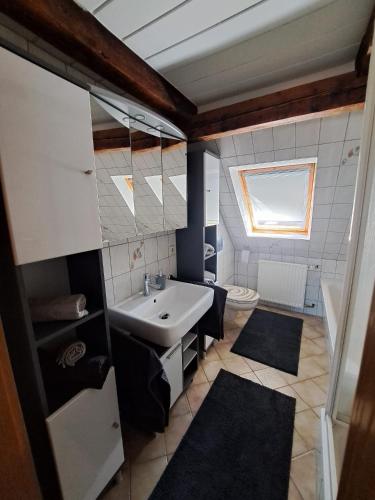 a bathroom with a sink and a toilet at Ferienwohnung Feldblick in Saal