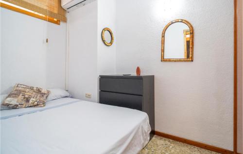 a bedroom with a bed and a dresser and a mirror at Gorgeous Apartment In Mlaga With House Sea View in Málaga