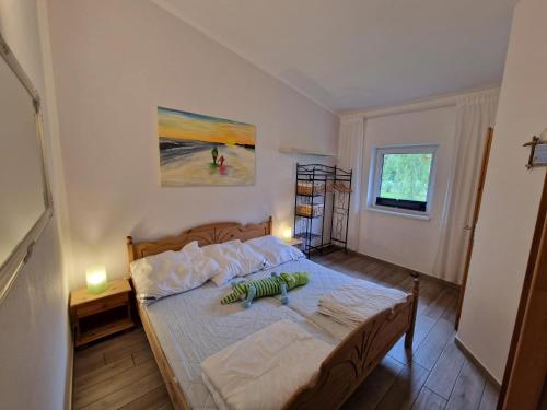 a bedroom with a bed in a room with a painting at Apartment Waldblick vom Naturhof Usedom in Bannemin