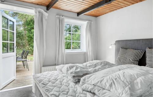 a white bedroom with a bed and a window at 3 Bedroom Nice Home In Gilleleje in Gilleleje