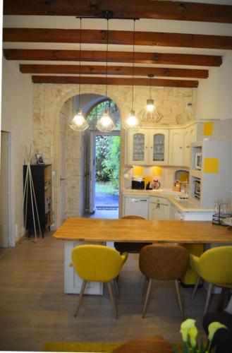 une cuisine avec une grande table et des chaises en bois dans l'établissement Le Chateau, à Évian-les-Bains