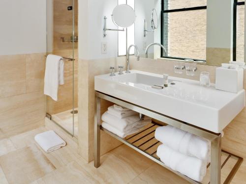a bathroom with a sink and a mirror at Bryant Park Hotel in New York