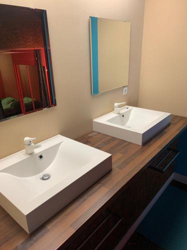 une salle de bain avec deux lavabos et un miroir dans l'établissement Évasion du préhaut, à Tournehem