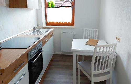a small kitchen with a table and a sink at Schöner Blick 