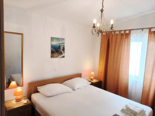 a bedroom with a white bed and a mirror at Villa Merica in Trogir