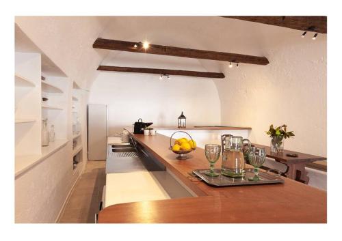 a kitchen with a table with glasses on it at Apanemo seaside house in Spetses