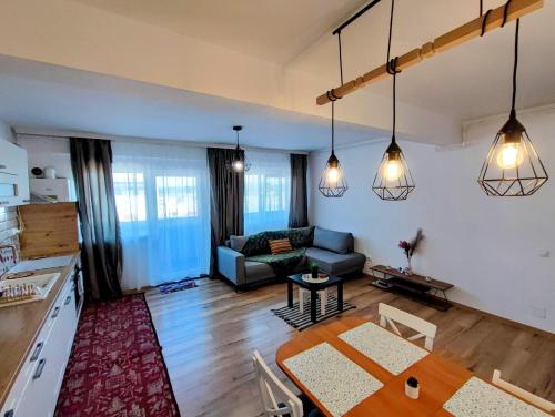 a living room with a table and a couch at River side apartment with terrace in Floreşti