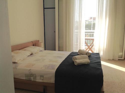 a bedroom with a bed with two towels on it at Aegean colors apartment in Marmarion