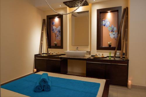 a bathroom with a sink and a large mirror at Cleopatra Luxury Resort Sharm El Sheikh in Sharm El Sheikh