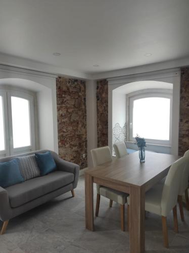 a living room with a table and a couch at Casa da Maria By Viva a Vida - Alojamentos & Hotels in Constância