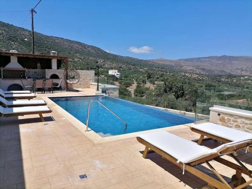 a swimming pool with a view of a mountain at VILLA HALEPOURI in Chania