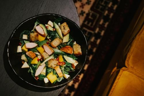 a black bowl of food with vegetables in it at Apartamenty Chełmińskie in Chełmno
