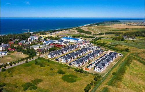 an aerial view of a parking lot next to the ocean at 1 Bedroom Amazing Apartment In Darlówko in Darłówko