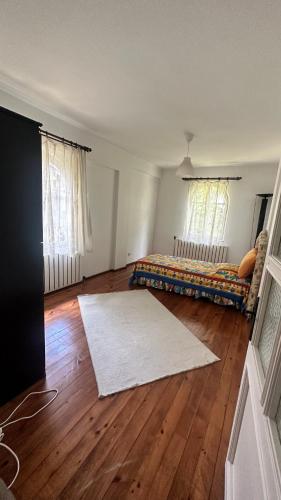 a living room with a bed and a white rug at Villa by Lake Sapanca in Sapanca