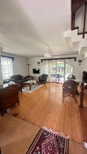 a large living room with wooden floors and furniture at Villa by Lake Sapanca in Sapanca