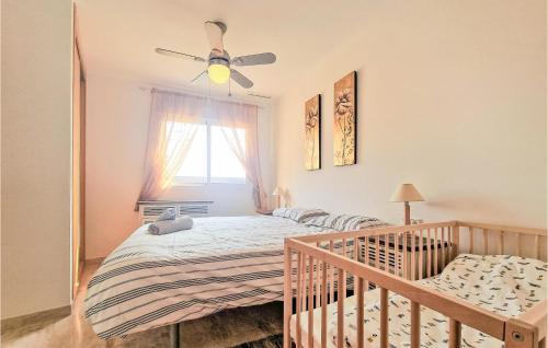 - une chambre avec un lit bébé et un ventilateur de plafond dans l'établissement 2 Bedroom Amazing Apartment In La Tercia, à Lo Mendigo