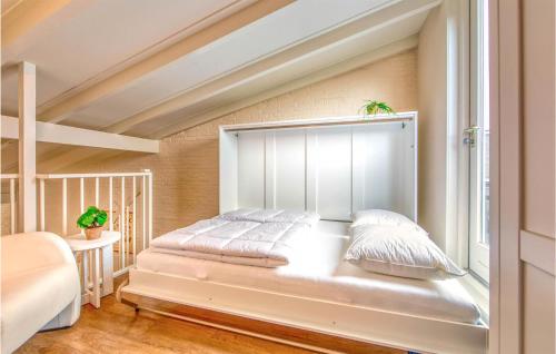 a bed in a room with a window at Gorgeous Apartment In Schiermonnikoog in Schiermonnikoog