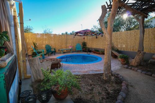 a backyard with a swimming pool and a fence at The Desert House in Uis