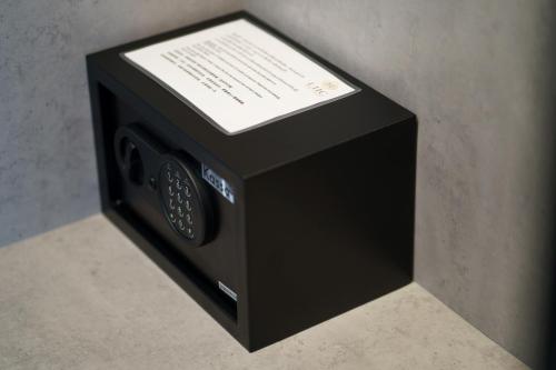 a black microwave oven sitting on top of a counter at LHC HOTEL AND RESORT in Pattaya Central