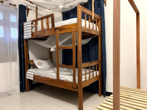 a bunk bed in a room with a bunk bed in a room at Serene Abodes in Stone Town