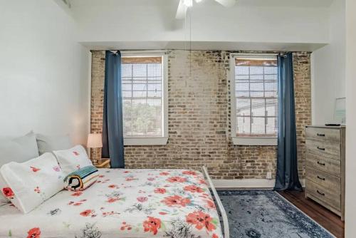 um quarto com uma cama e duas janelas em Historic District Apartment Quiet Street Central Location! em Mobile