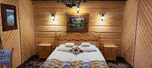sypialnia z łóżkiem w drewnianym domku w obiekcie Chata Góralska i Pokoje Gościnne w Ciechocinku