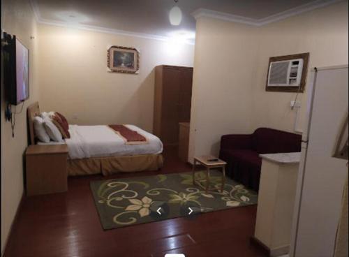 a hotel room with a bed and a couch at Zahret Al Madinah in Medina