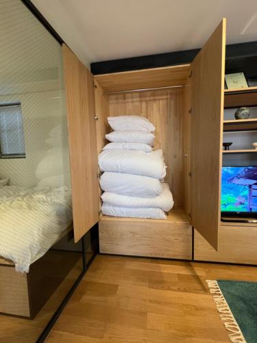 a pile of towels in a closet next to a bed at Korean Traditional Ikseon House in Seoul